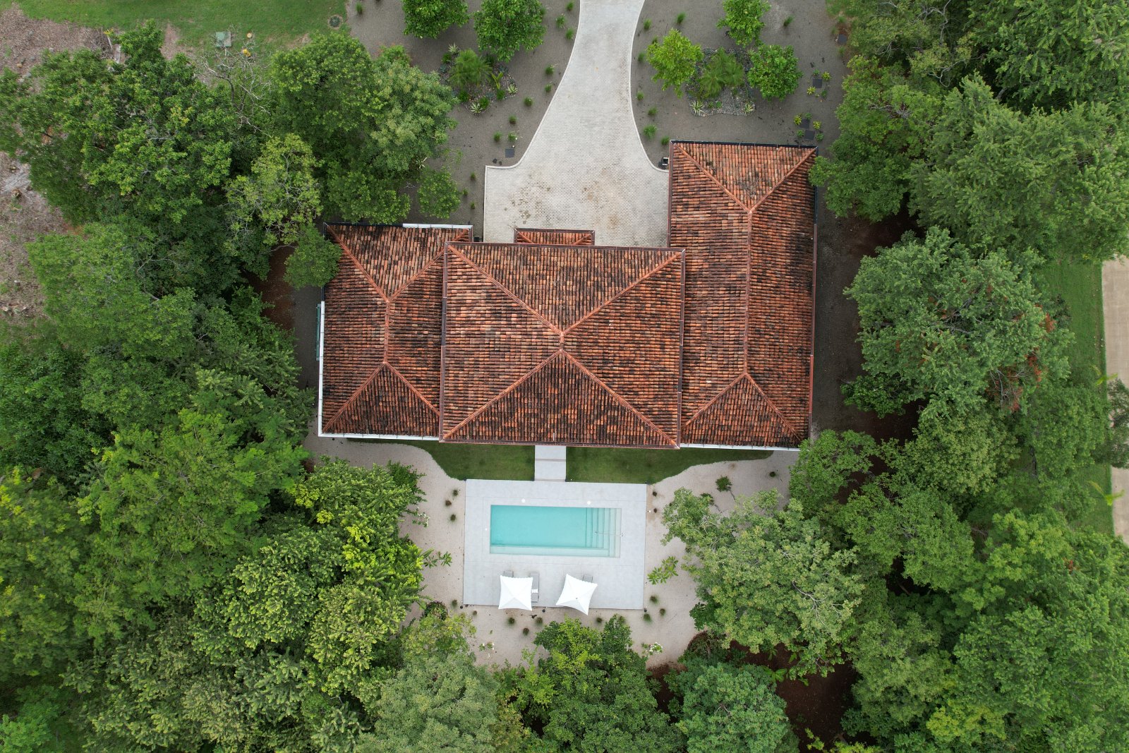 Aerial view of Casa Vida in Hacienda Pinilla, sited among existing trees by CJarq