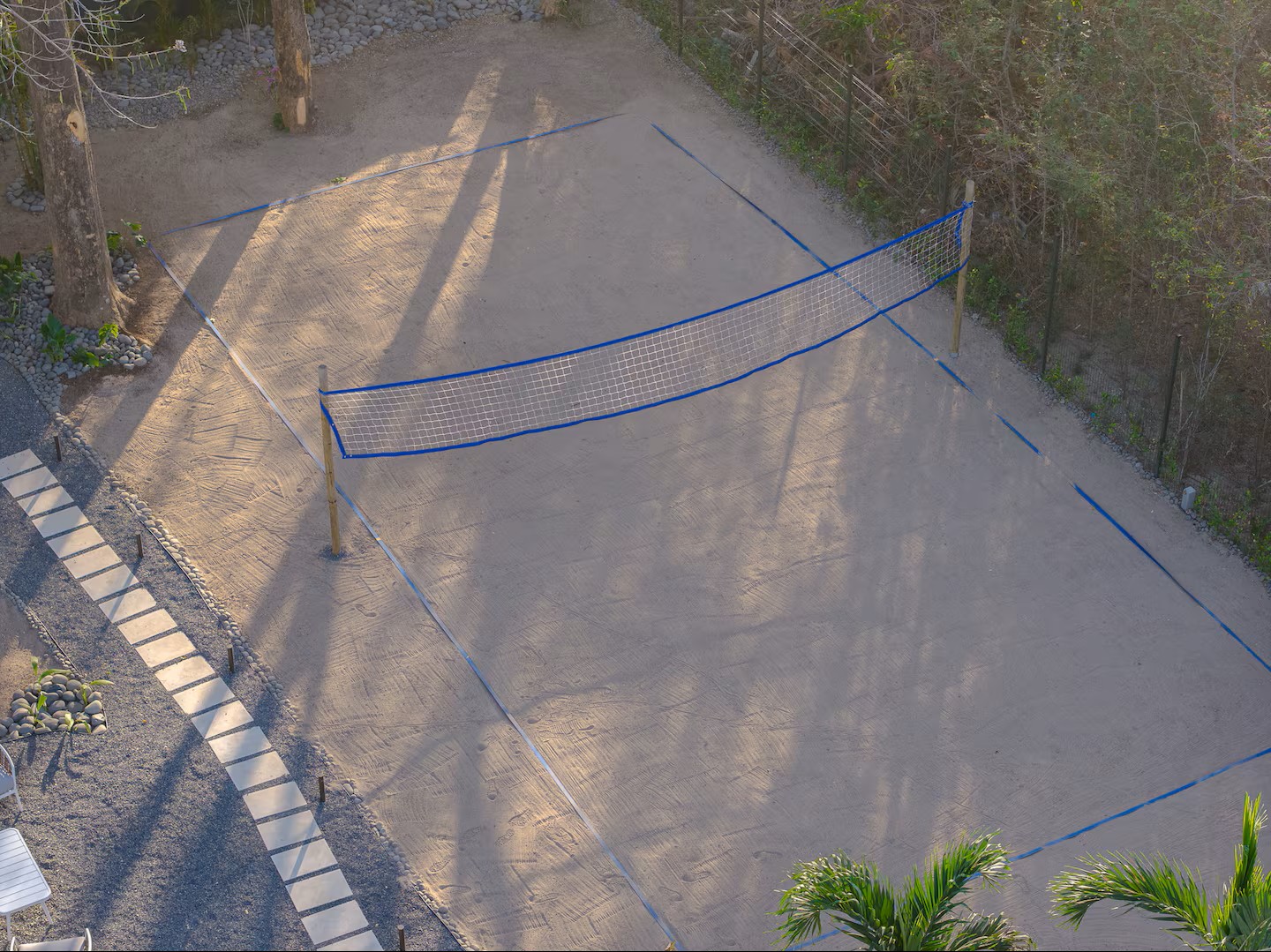 Aerial view of the sand volleyball court and stepping-stone path, Villa Viva landscape, Playa Grande